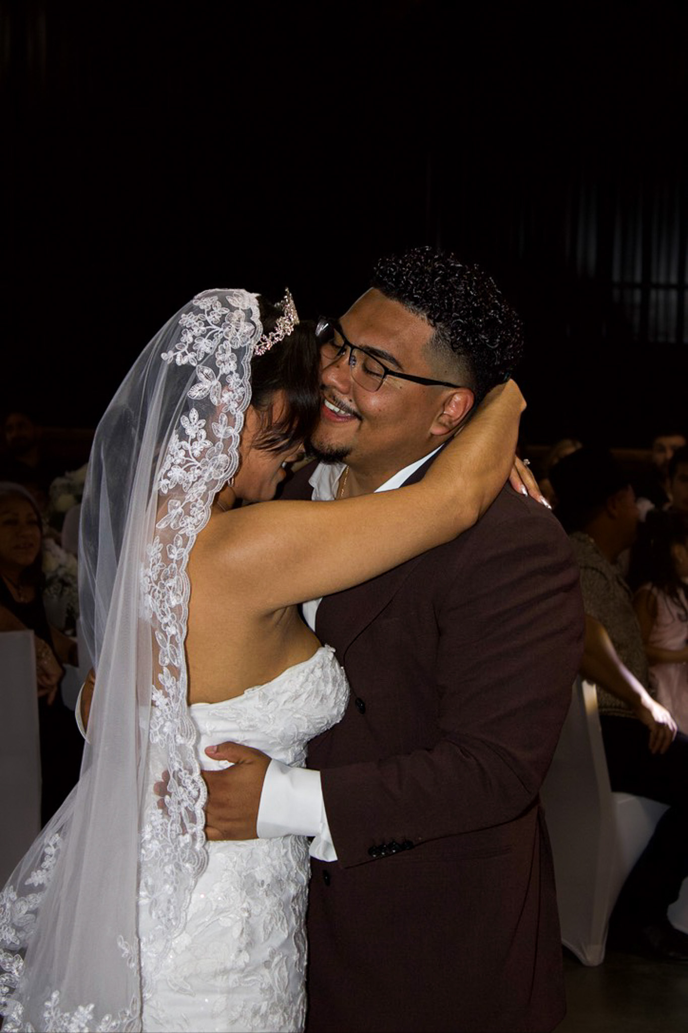 A newlywed couple embracing during their reception