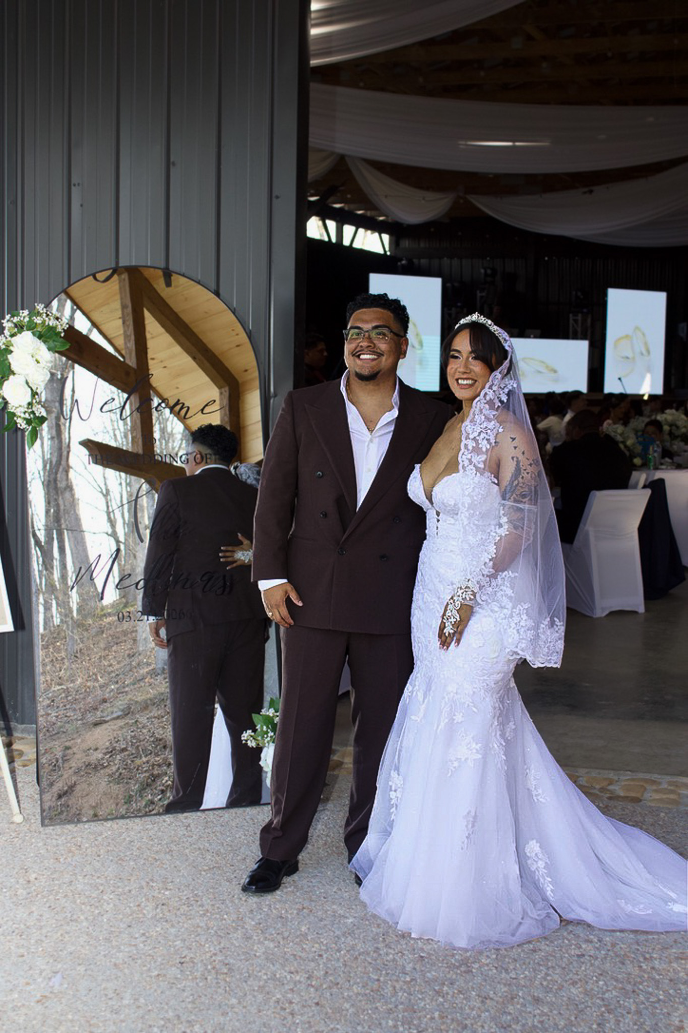 A bride and groom posing together at their reception