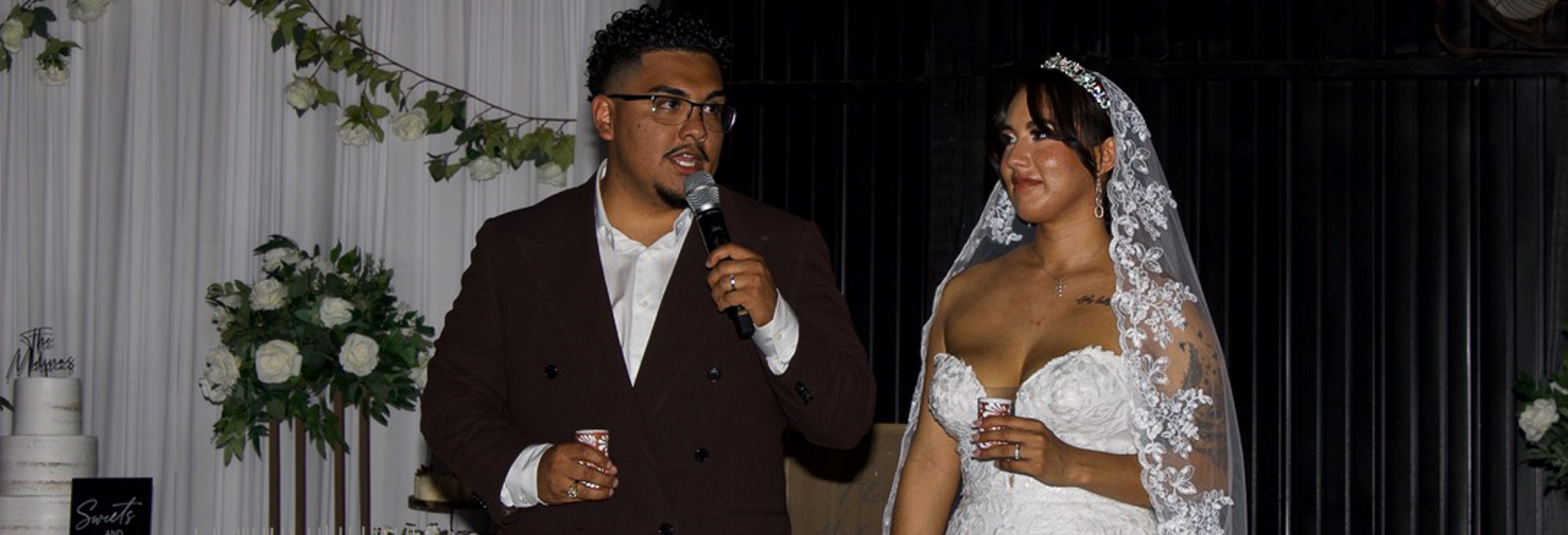 A bride and groom sharing a joyful toast